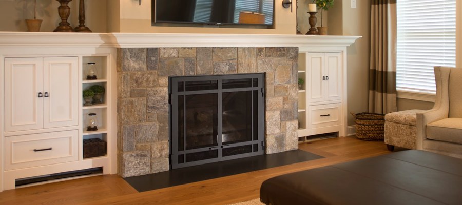 Interior stone veneer fireplace accent wall with built-in shelving